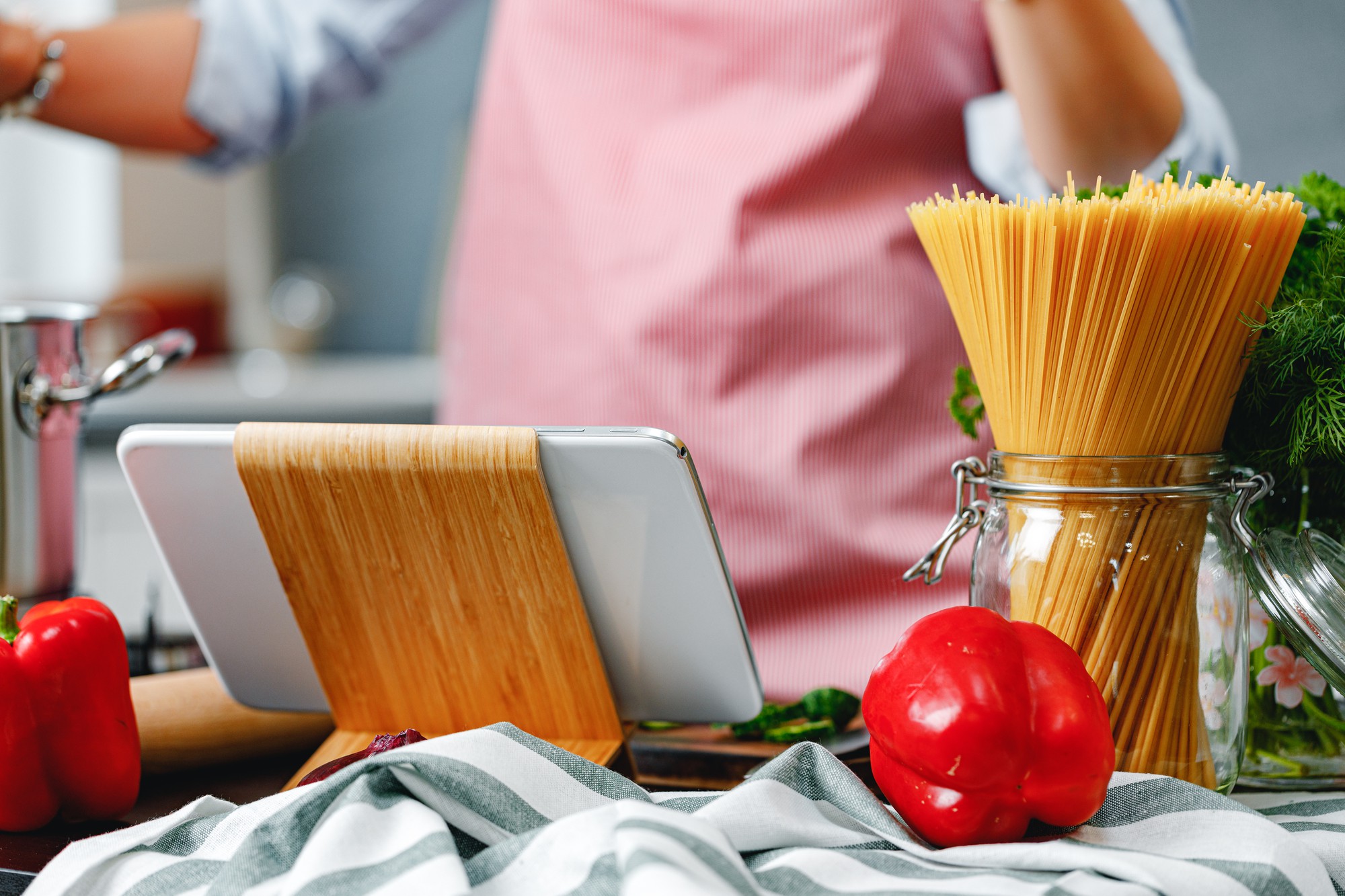 Kitchen workspace with cooking tools and laptop