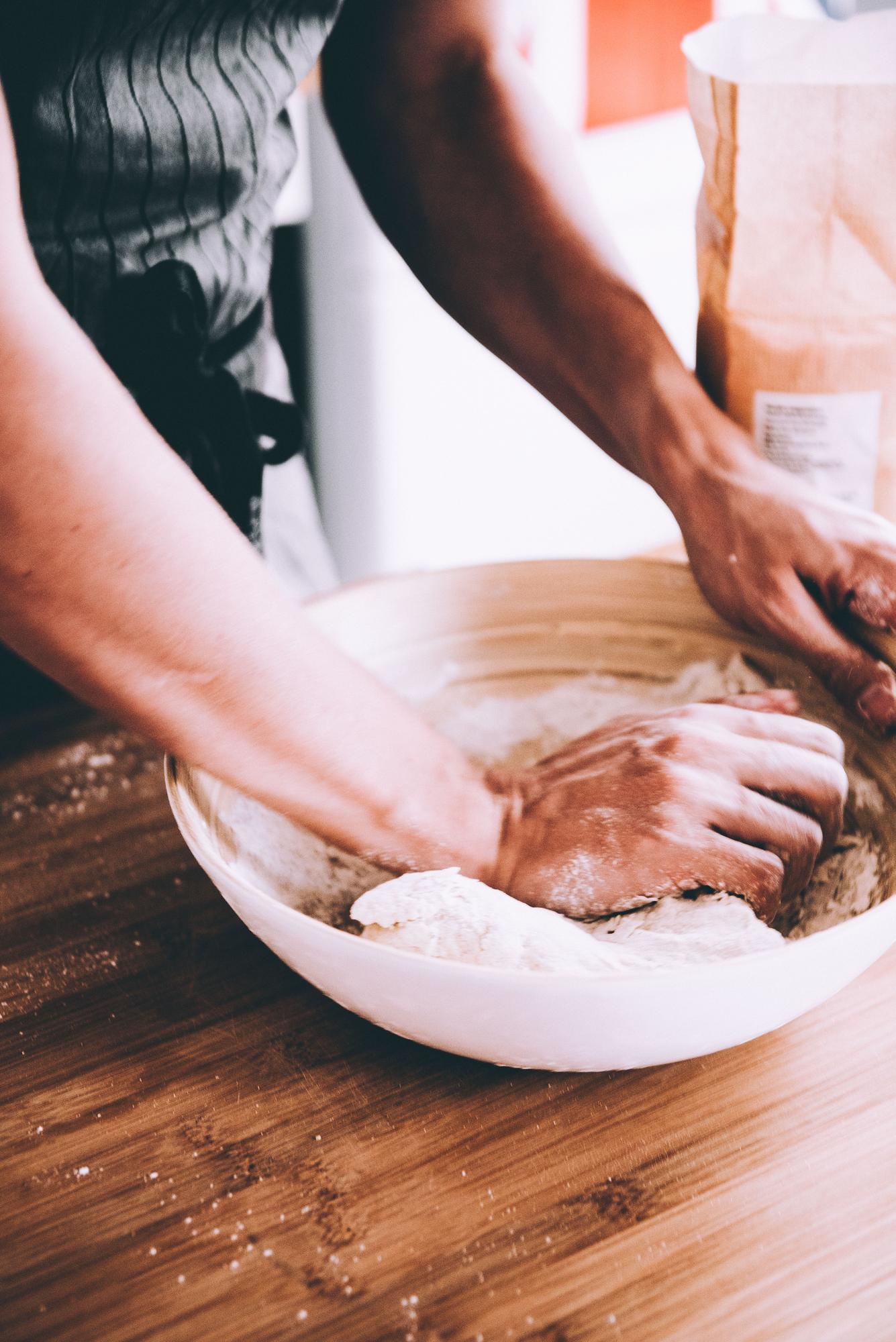 Close-up of hands preparing dough
